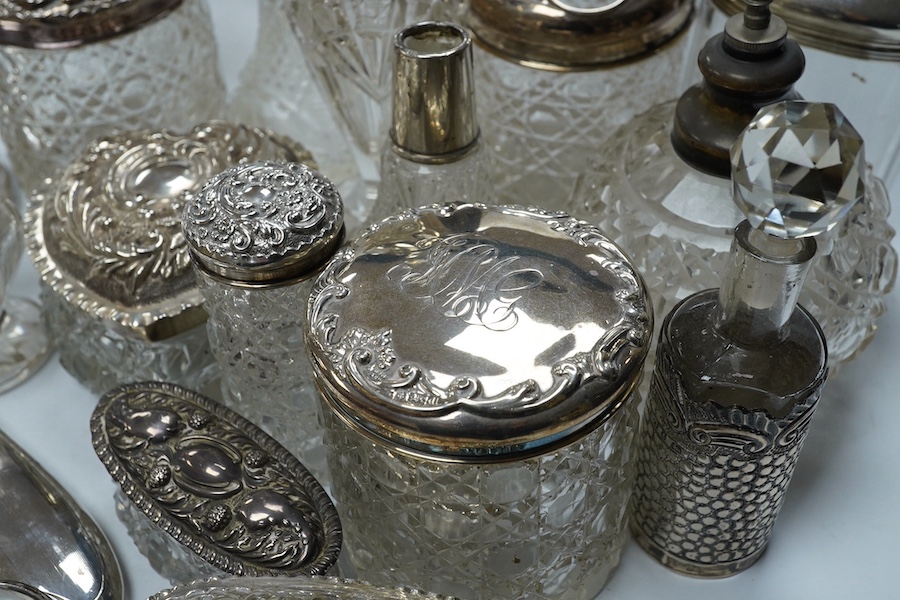 Two silver mounted hand mirrors and a collection of seventeen assorted silver mounted toilet jars. Condition - poor to fair